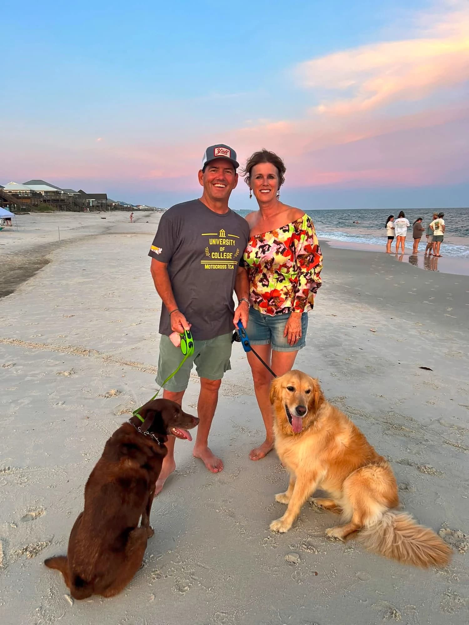 Frank and family on the beach at sunset with their two dogs