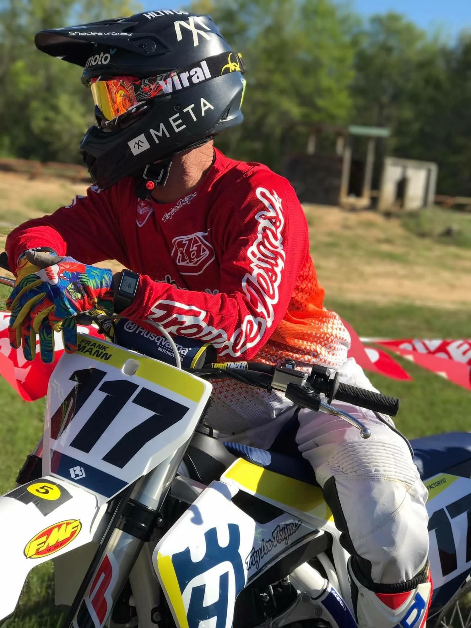 Frank on his number 117 bike in a Meta helmet and red jersey