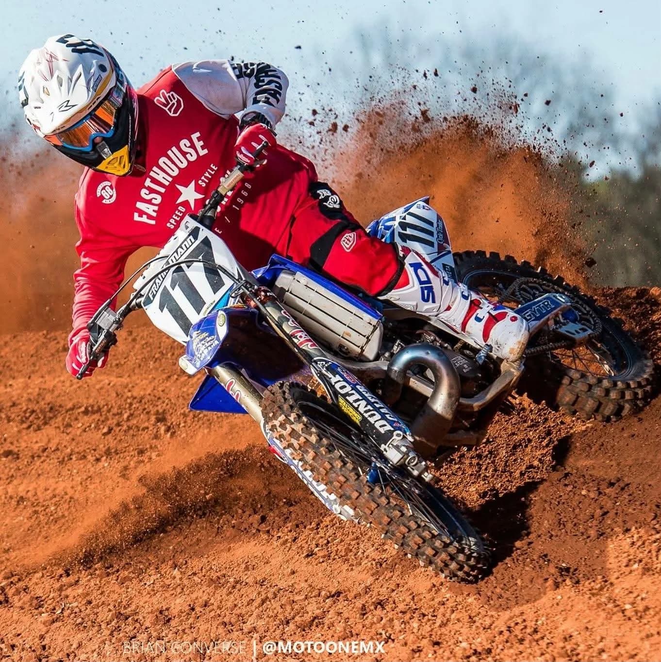 Frank throwing dirt through a turn on his number 117 bike