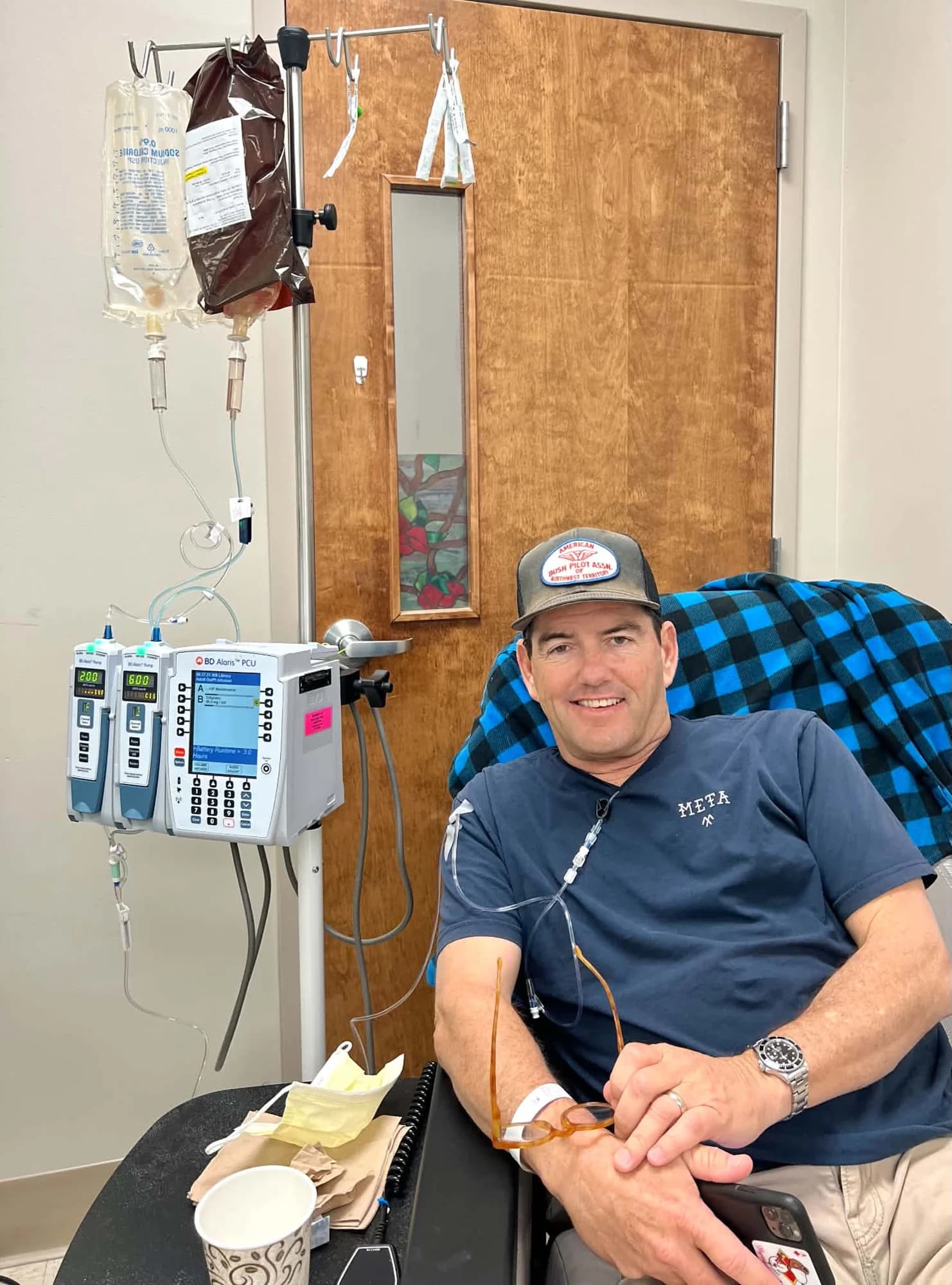 Frank smiling in an infusion chair during treatment
